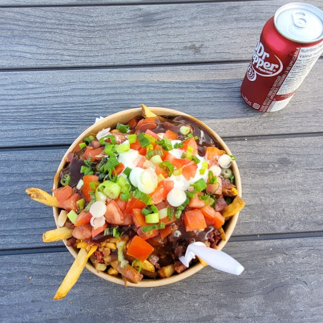 A spread of loaded fries and potato dishes